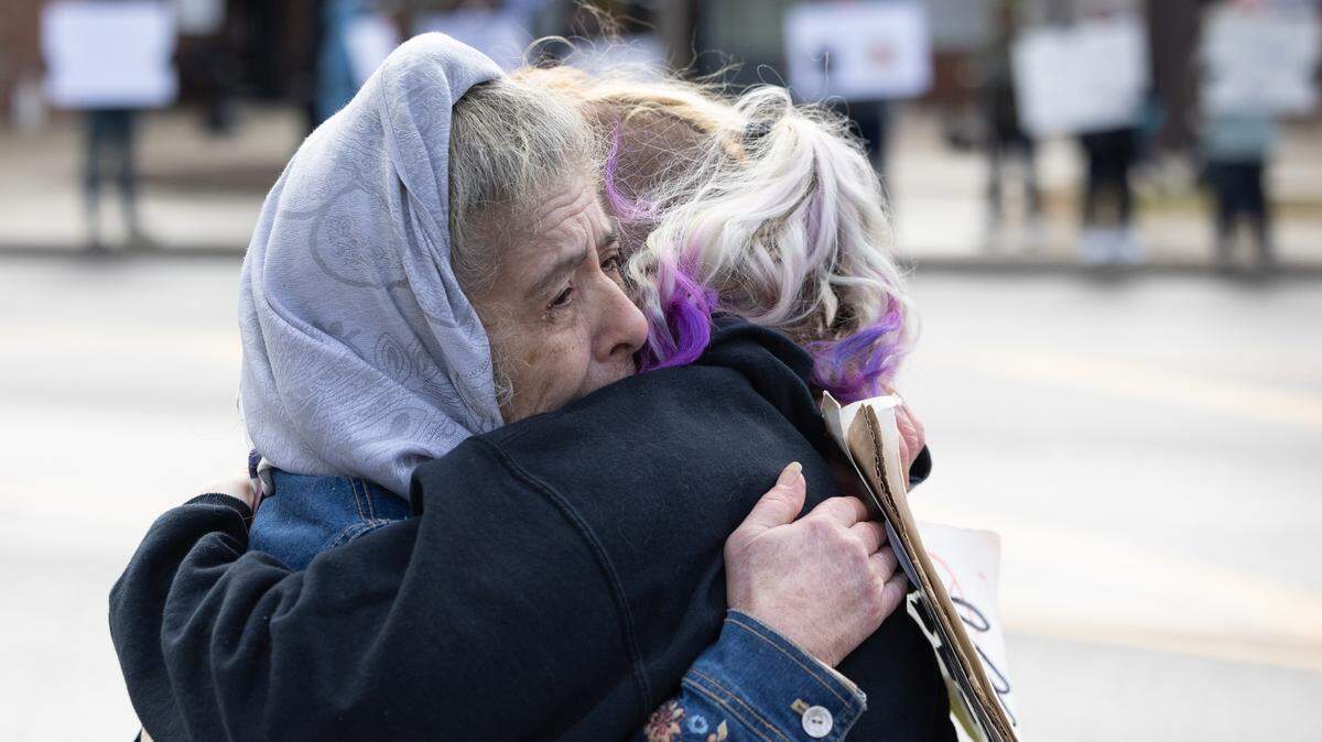 Peggy Schuenemeyer hugs a nearby protester during a demonstration at Belleville’s Public Square on Saturday, Jan. 10. “I don’t know who she is, but I saw her crying and held her,” Schuenemeyer said. “I remember feeling that same way during the Vietnam War. It’s what I would’ve needed.”