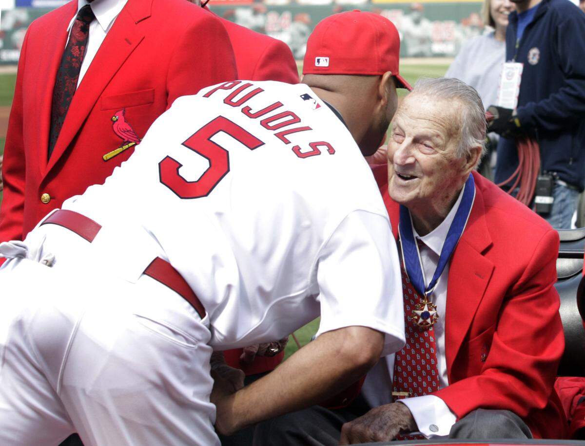 St. Louis Cardinals first baseman Albert Pujols, left, greets the late Stan Musial, a former Cardinals’ great and Hall of Famer, before the start of a game in 2011. The Cardinals officially announced Monday afternoon they’ve signed Pujols to a one-year contract, and Pujols in turn announced to assembled media at a press conference at the Cardinals’ Florida complex the 2022 season would be his last in Major League Baseball.