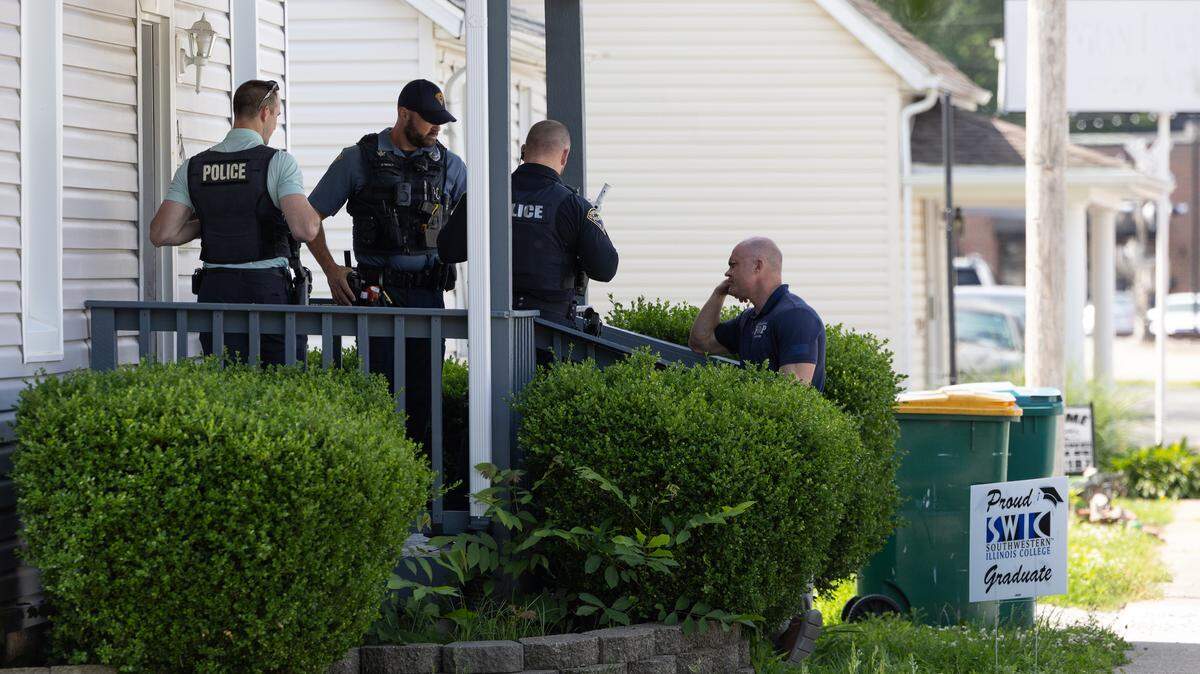 Investigators gather evidence at the scene of a shooting that occurred at a duplex on N. Vine St. in O’Fallon on May 21.