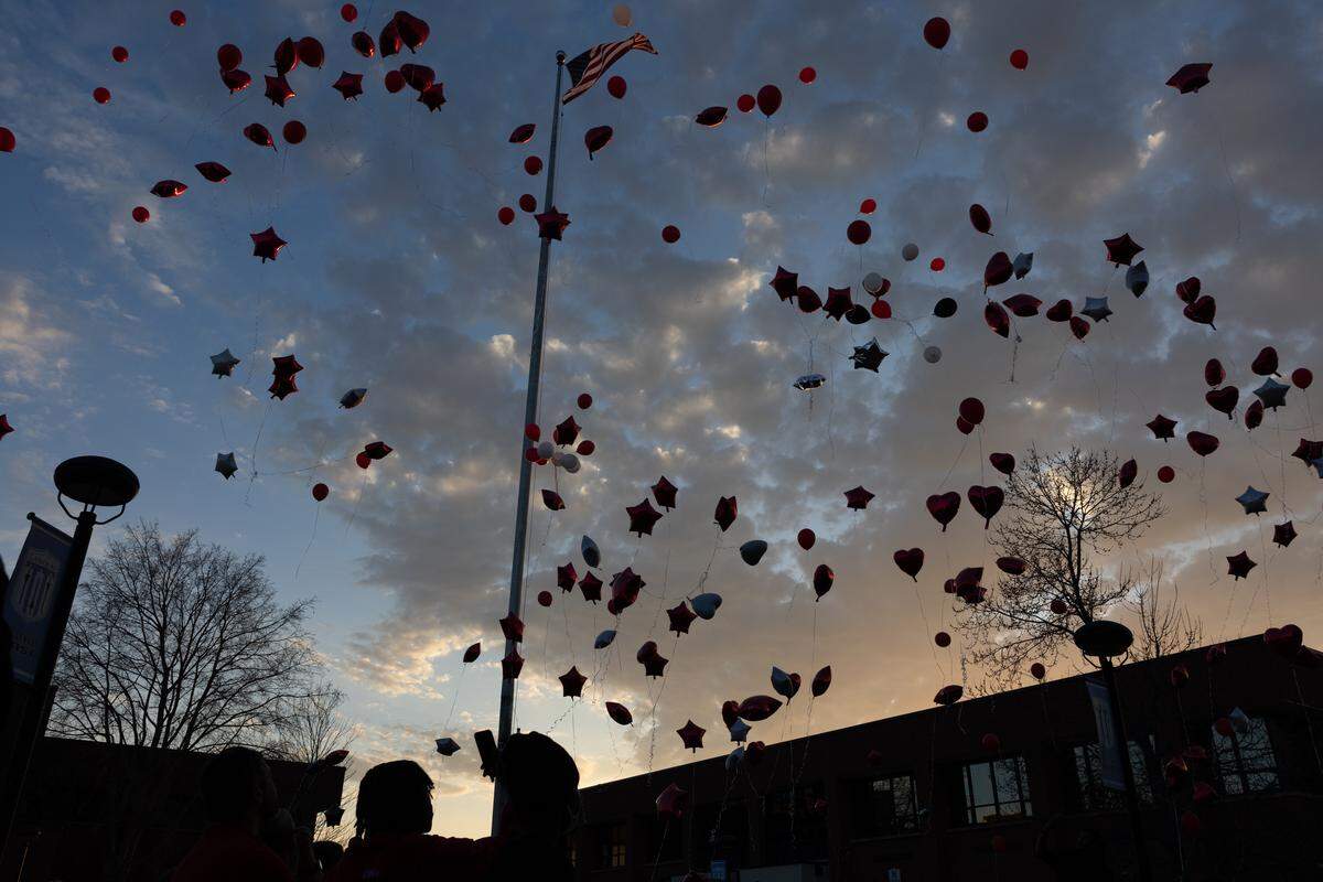 Hundreds of balloons are released in honor of Jarod Rhodes, a Belleville East student who died last Friday.