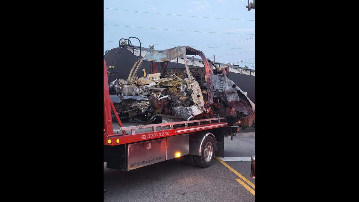 The charred wreckage of an F-150 pickup truck that collided with a Union Pacific train on Saturday at a railroad crossing in Sauget is shown on the back of a trailer after being removed from the accident scene.