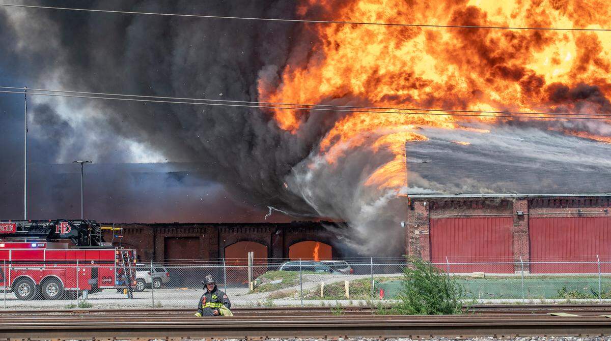 Hundreds of firefighters from across the St. Louis and Southwestern Illinois region work to battle a large recycling warehouse fire in Madison, Illinois.