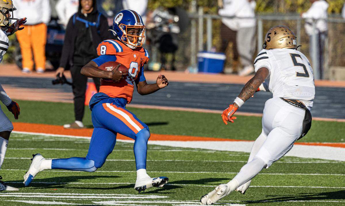 East St. Louis’ Kendrick Lyons (8) carries the ball while under pressure during the Flyers’ Class 6A semifinal win over Oak Lawn Saturday.