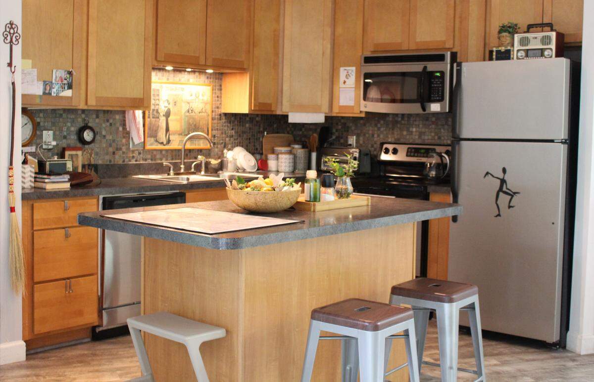 The kitchen has been modernized at one end of the great room in the Farthing home, which was designed by Belleville architect Charles King and built in 1950.