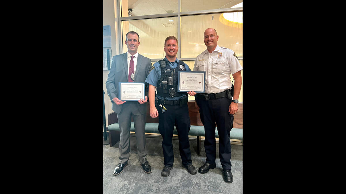 O’Fallon Police officers Chad Finnan and Nick Luttrell self-dispatched to a Shiloh Police Department and EMS call because of their proximity to a bodybuilder suffering a cardiac arrest as a passenger in a car en route to Kentucky. They took over from an unidentified bystander and began lifesaving measures until O’Fallon-Shiloh EMS arrived at the scene. Because of their decisions to respond and prompt actions, they saved a life. Pictured from left, O’Fallon Police Officers Chad Finnan and Nick Luttrell with Police Chief Kirk Brueggeman received Lifesaving Awards.