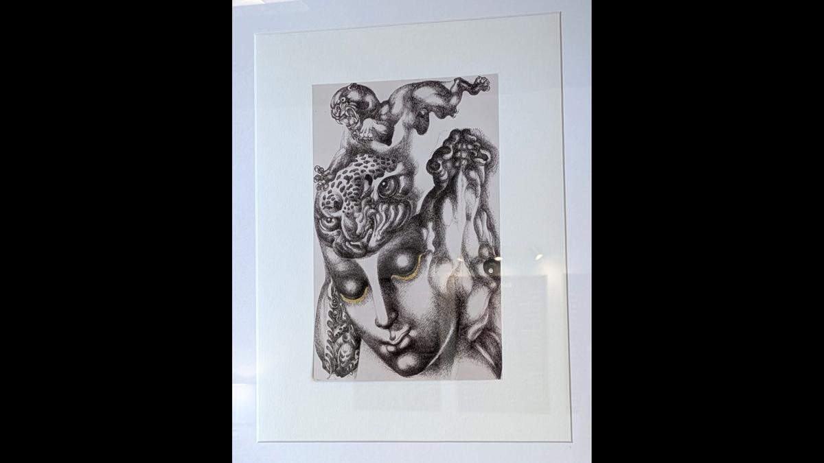 Framed prints of works by Thai artist Thawan Duchanee hang on the walls at Banana Leaf.