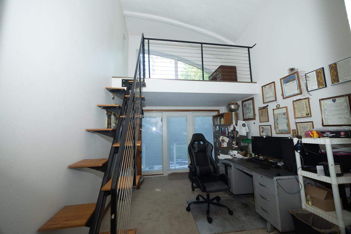 A writer’s loft, accessible through a series of unique witch’s stairs, sits in the upstairs half of the home.