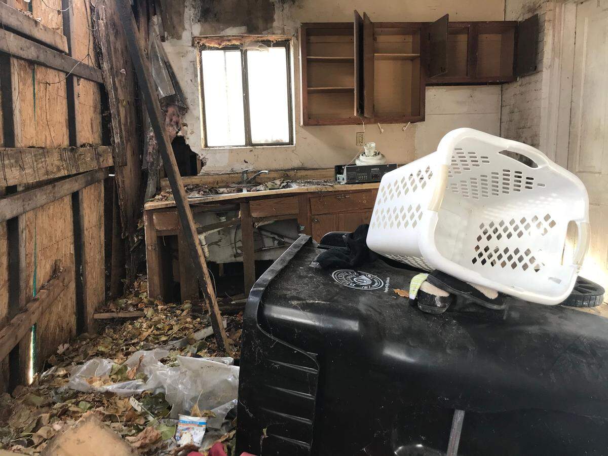 Squatters have filled the added-on kitchen of a German American folk house at 214 N. 11th St. in Belleville with household junk and trash. The city is preparing to demolish it.