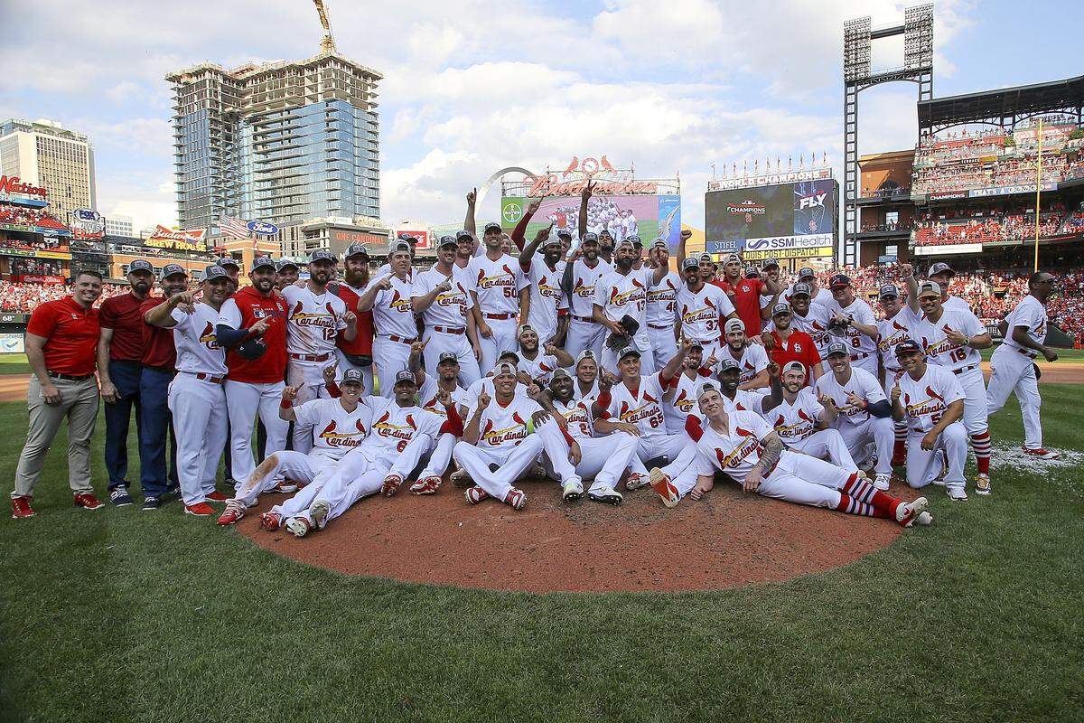 Members of the St. Louis Cardinals pose for a group picture as they celebrate their victory after a baseball game Sunday, Sept. 29, 2019, in St. Louis. The Cardinals clinched the NL Central on the final day of the regular season, to win their first division title since 2015 with a 9-0 victory over the Chicago Cubs. (AP Photo/Scott Kane)