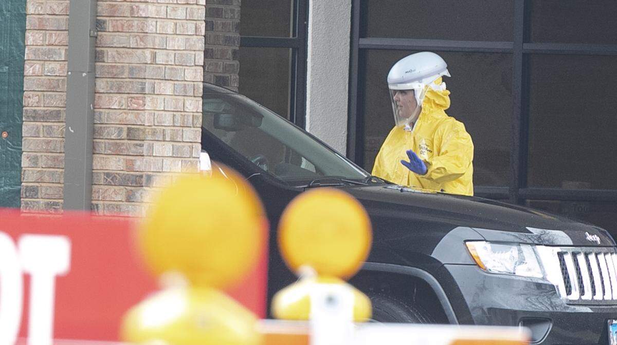 Healthcare workers prepare for the opening of the coronavirus, COVID-19, drive-through testing center in Swansea, Illinois Thursday. You will only be allowed to go to the “specimen collection” site if you have prior authorization from your doctor and your local health department.