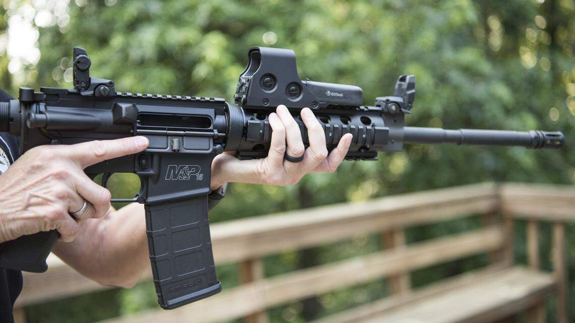 In this AP file photo from June 24, 2016, an AR-15 is held in Auburn, Ga.