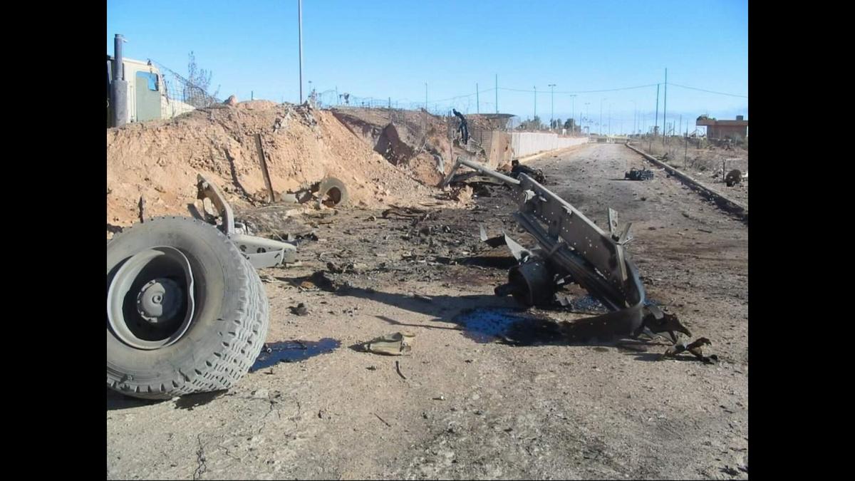 Parts from the white truck used in the suicide bombing in Trebil, Iraq litter the ground on Dec. 4, 2004. Matt Hetrick, the platoon sergeant, said the remnants of the wreckage lasted long after the bombing.