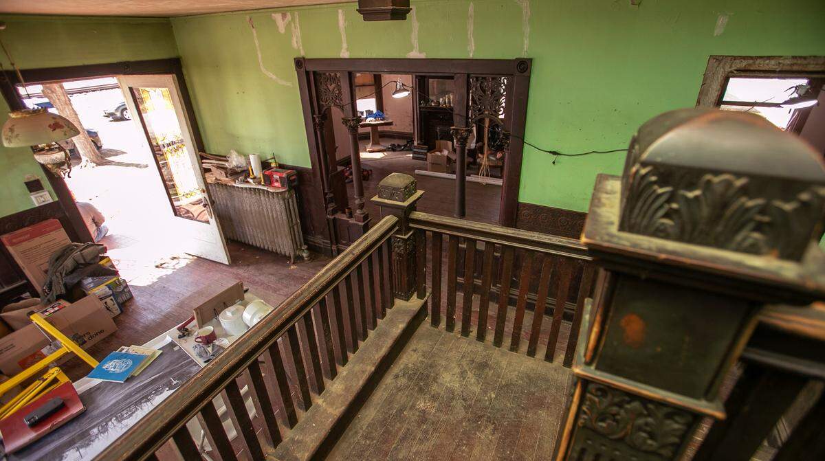 “The Pink House” in Aviston is full of unpainted woodwork and pine floors. This is the view from the massive staircase in the foyer. The home now is under renovation.