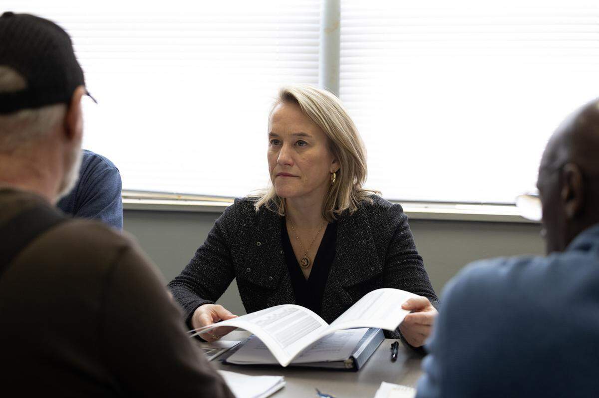 Congresswoman Nikki Budzinski speaks with Calvin Ratliff (R) and Larry Burgan (L) about the long-term effects of radioactive waste in Venice, Ill. on Jan. 12, 2025.