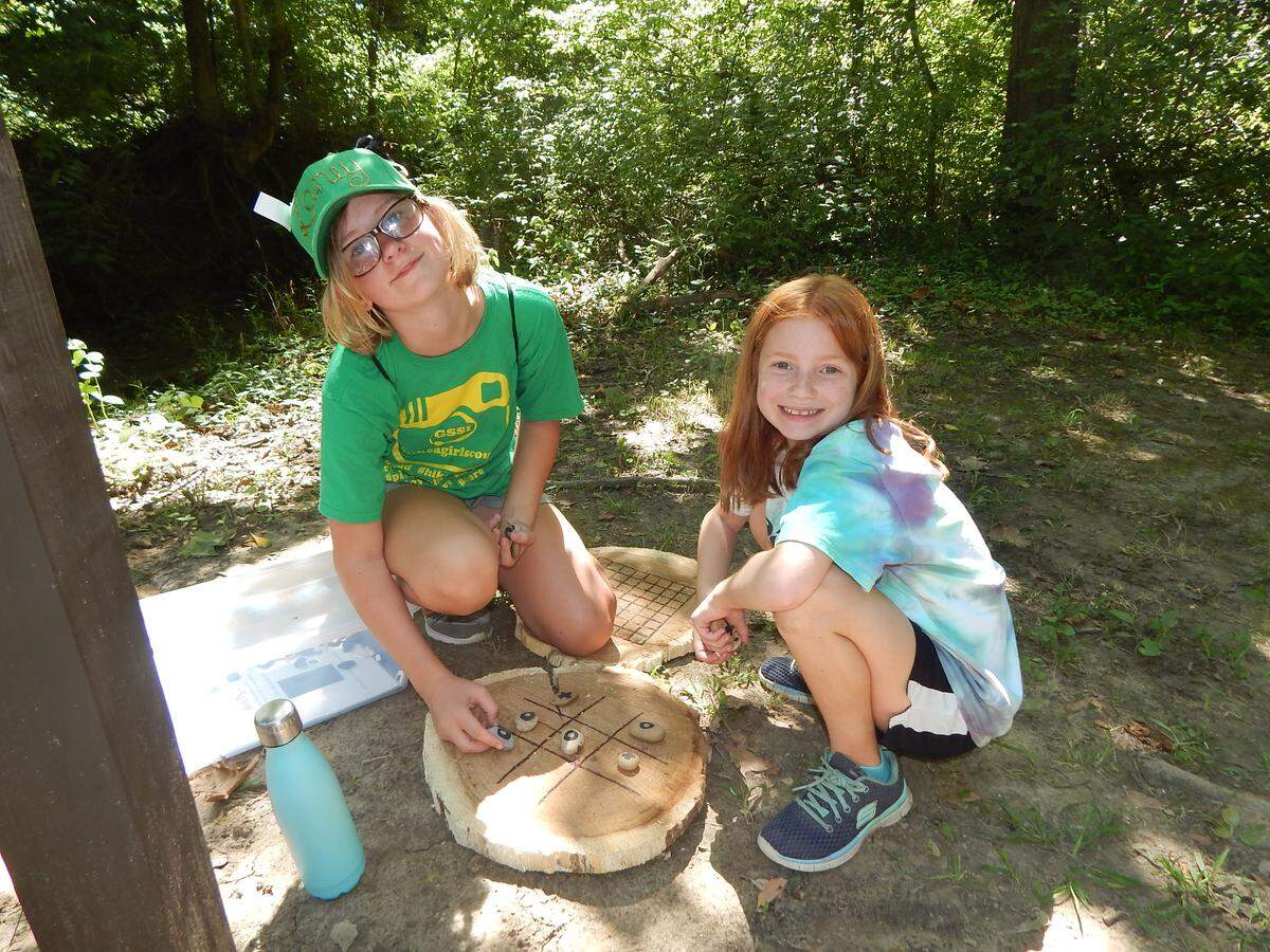 In this file photo, Laney Brandenburg and Karly Kalette play outdoor games that Leah created in 2018 for Camp Torqua near Edwardsville. The camp is owned by the Girl Scouts of Southern Illinois.
