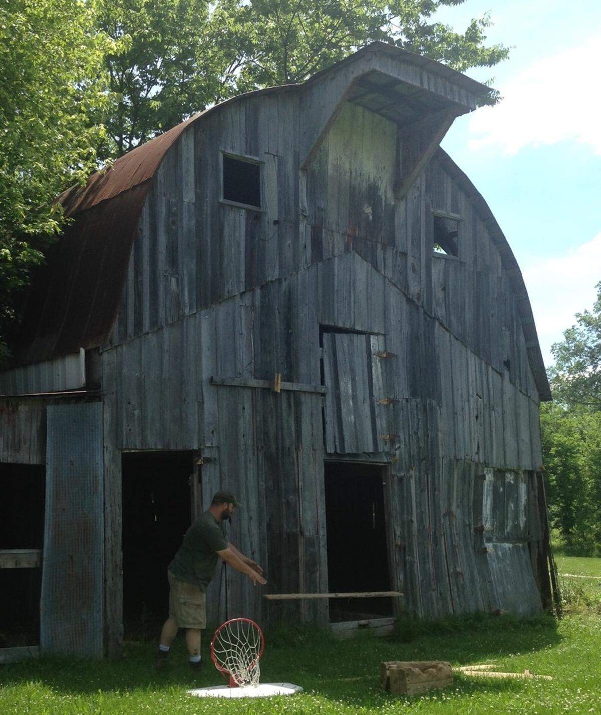 Dave Green, of Carlinville, clearing an old barn, which was the first barn he torn down with his family’s help. Green said he’s torn down and preserved materials and artifacts from about a dozen projects in the last couple years.