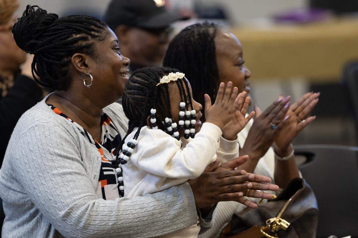 The family of BPI-Weatherization class speaker Martino Britt applaud as his name is called during a ceremony for graduates of the Illinois Climate and Equitable Jobs Act (CEJA)-funded East St. Louis Clean Jobs Workforce Network Program.