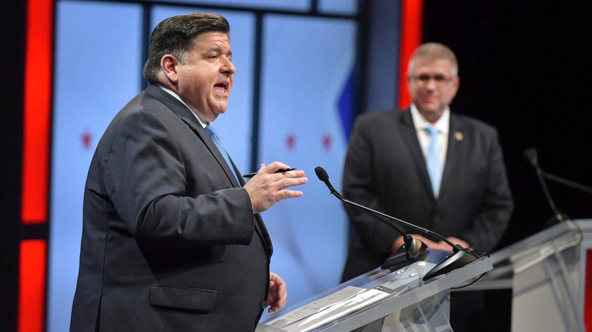 Illinois Gov. JB Pritzker, left, speaks as his Republican challenger state Sen. Darren Bailey, right, listens during the Illinois Governor’s Debate.