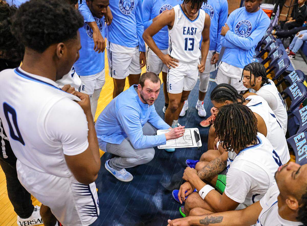 Belleville East head coach Jeff Creek talks to his team during a timeout Friday night against Belleville West. The Lancers ultimately posted a 66-57 Southwestern Conference victory.