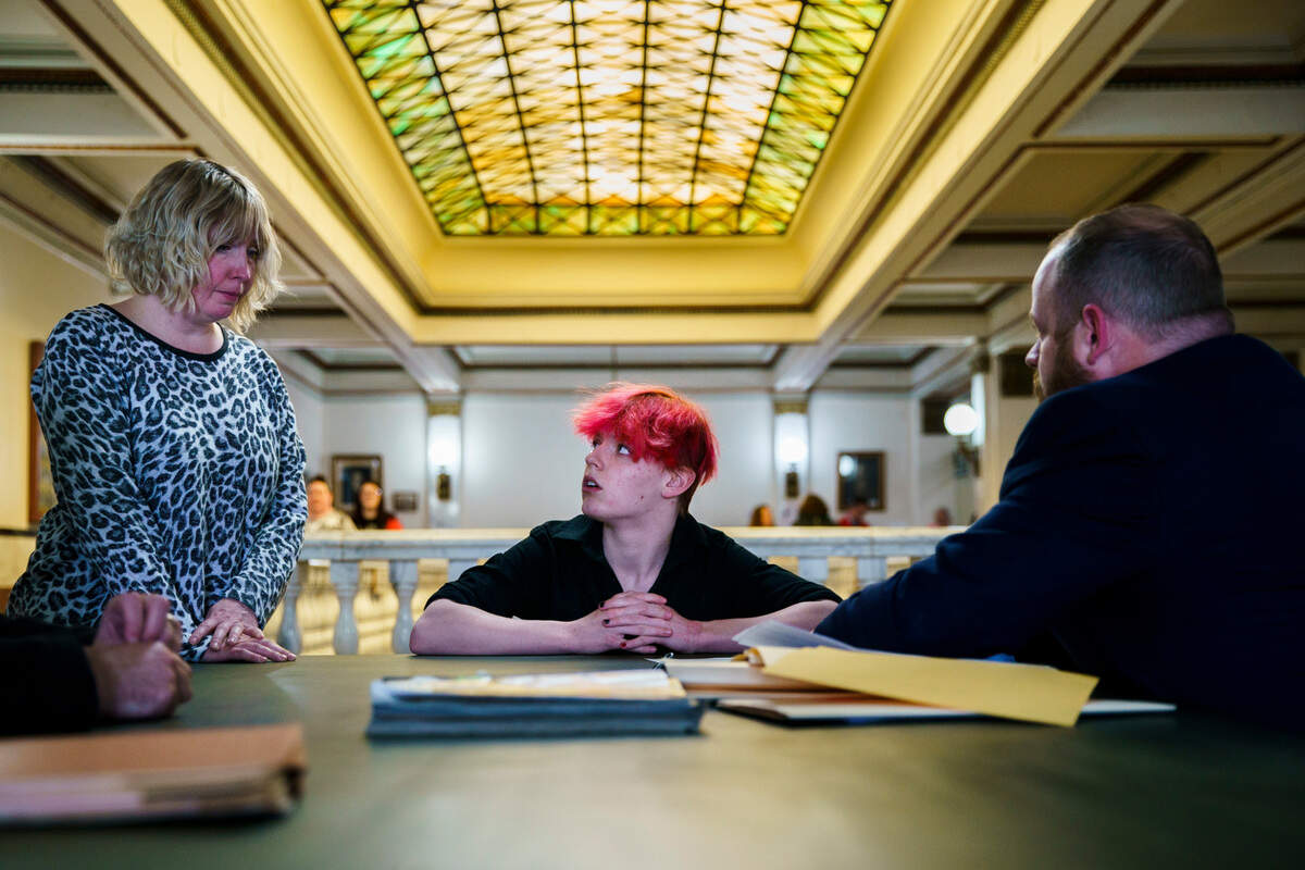 Jennifer Fee, left, stands near her child Blake, 17, as he talks to prosecutor Pat McGrath at the Tazewell County Courthouse in March. Blake had received a ticket for having a tobacco vaping device at Morton High School near Peoria.