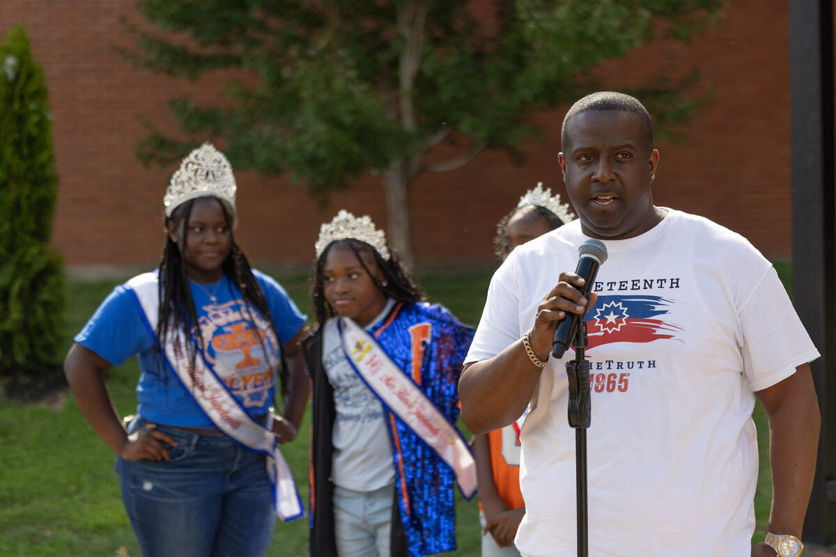 Shavon Wilson, Illinois state director of Juneteenth, leads a flag-raising ceremony in East St. Louis on 618 Day, June 18. The event also celebrated Juneteenth. “We would have no 618 day without the 619,” Wilson said.