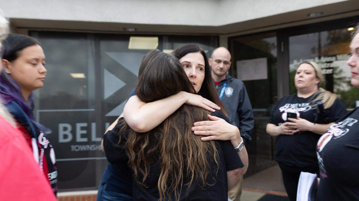 Ashley Mims, president of Local 434 teacher’s union, hugs Amy Morris, whose son died in December. The two met outside of a District 201 meeting on May 18, 2026.