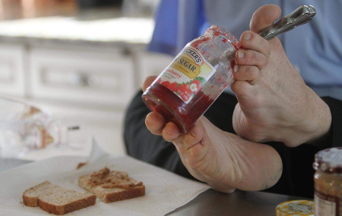 John Foppe makes a peanut butter and jelly sandwich for his daughter, Faith, after school.