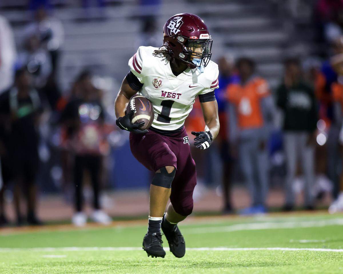 Belleville West's Isaiah Williams returns a kickoff during Friday night’s Southwestern Conference game in East St. Louis.