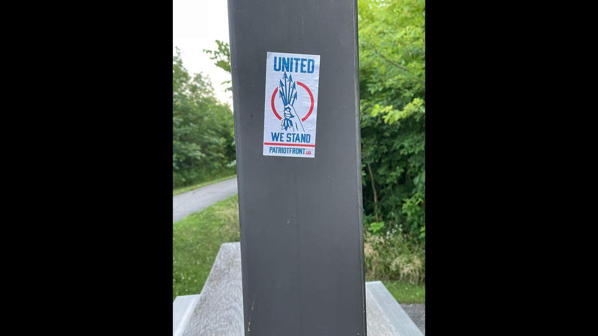 A Patriot Front sticker that was spotted Sunday by a hiker is attached to one of the posts on a picnic shelter along a trail at Silver Creek Preserve, a St. Clair County park south of Mascoutah.