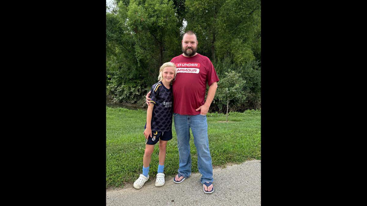 Ben Theis stands with his son, Wyatt, who is named after Matthew Wyatt, on July 25, 2024. Wyatt plays the drums, which Theis said is interesting because Matt Wyatt also played the drums in a band called “The Plaid Millies.”