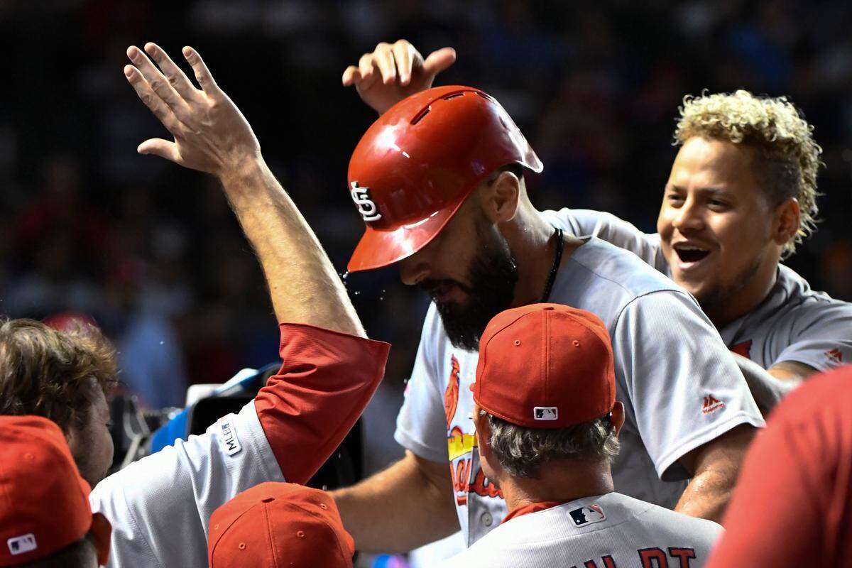St. Louis Cardinals’ Matt Carpenter, center, celebrates in the dugout with relief pitcher Carlos Martinez, right, after he hit a home run against the Chicago Cubs during the tenth inning of a baseball game Thursday, Sept. 19, 2019, in Chicago. (AP Photo/Matt Marton)