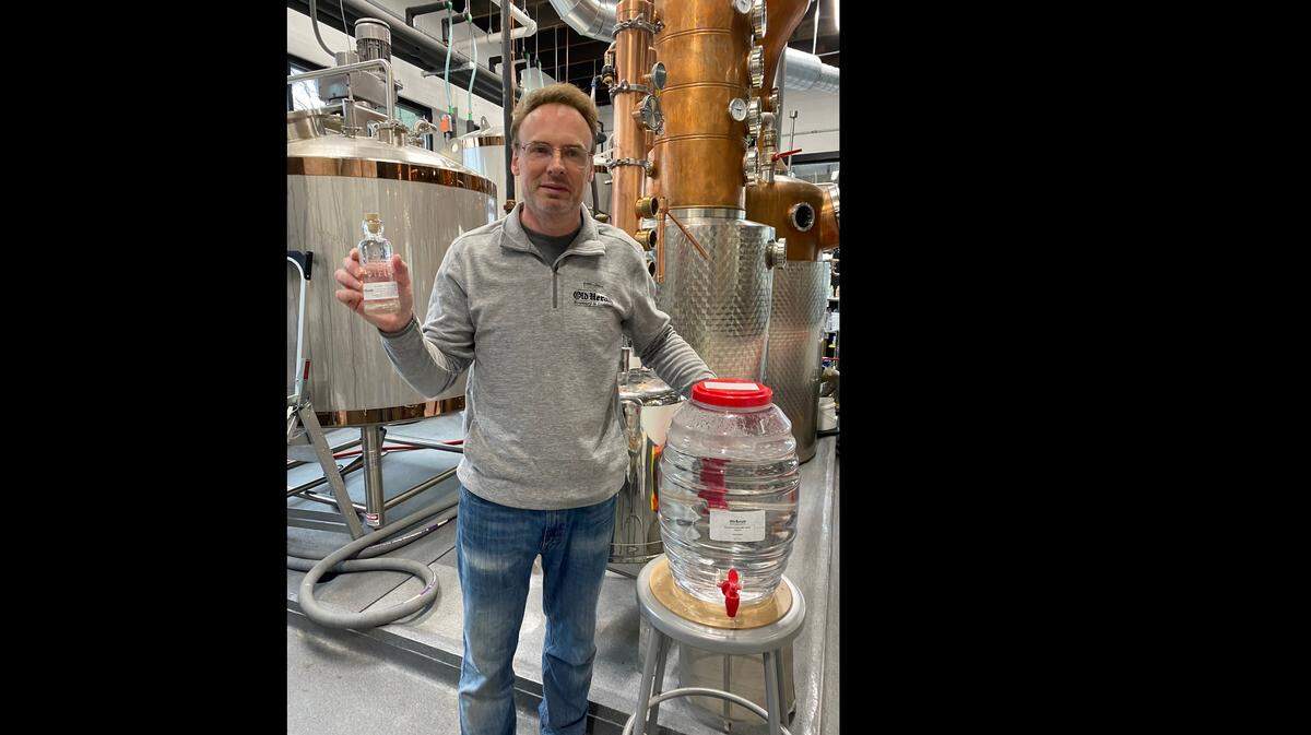Derik Reiser, co-owner of Old Herald Brewery & Distillery in Collinsville, holds a bottle of hand sanitizer that he is producing to help with the coronavirus-related shortage.