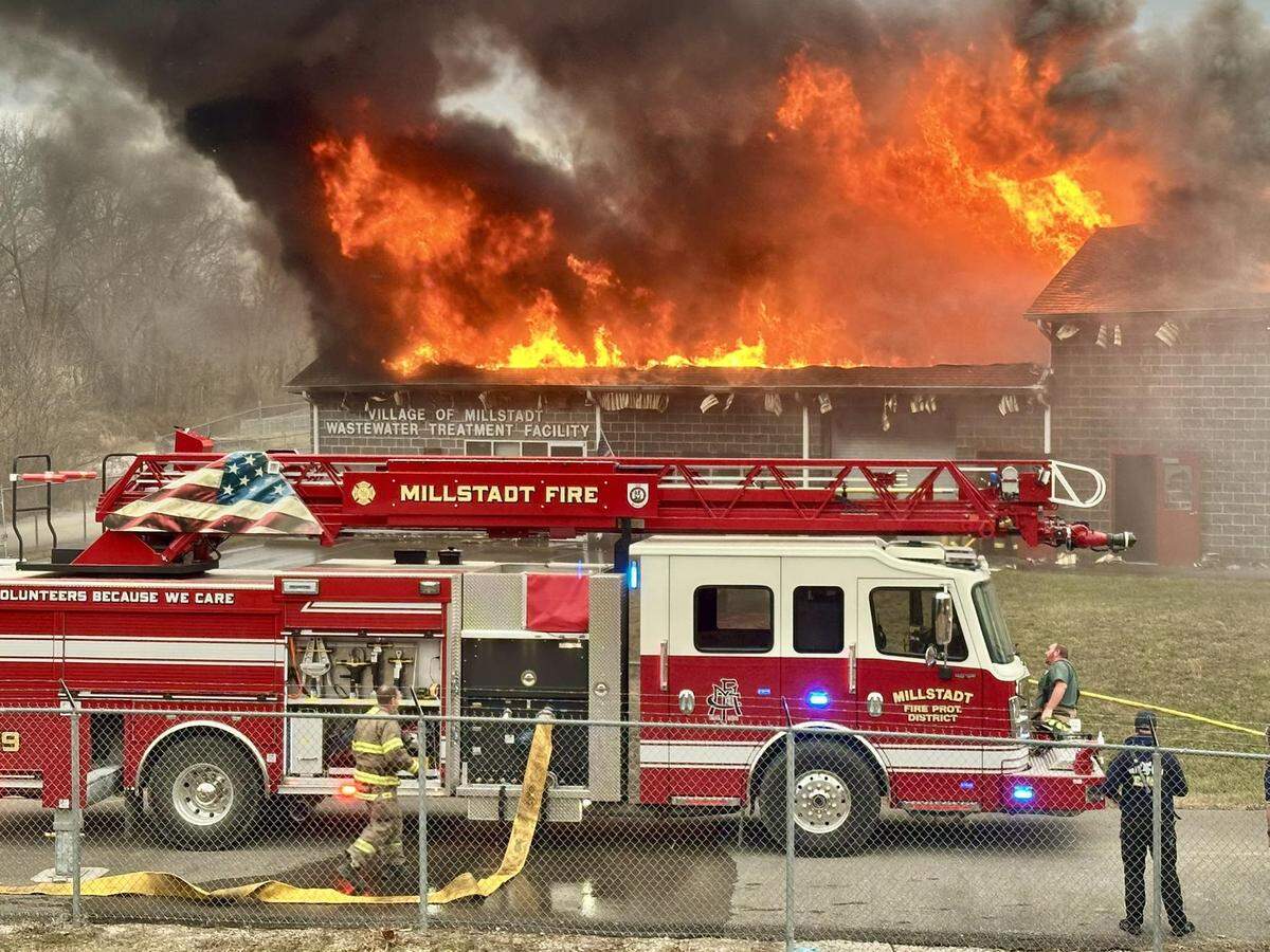 Millstadt firefighters set up outside the village’s wastewater treatment facility, which was engulfed in flames Tuesday afternoon.