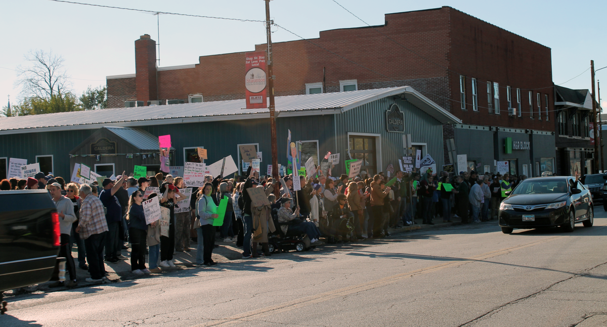 The driver of a passing car gives a peace sign to hundreds of people who attended a rally Sunday in Staunton in support of local father and Caldera Bar and Grill owner Ismael Ayuzo Sandoval, who was taken into custody by U.S. Immigration and Customs Enforcement on Oct. 29.