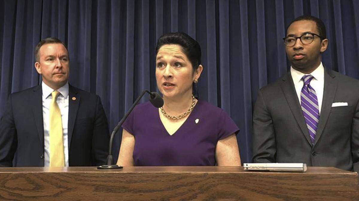 Illinois state Comptroller Susana Mendoza accompanied by Sen. Andy Manar, D-Bunker Hill, left, and Rep. Christian Mitchell, D-Chicago, right, explains her "truth-in-hiring" legislation that would require the current and future governors to pay employees who report to them from their budgets instead of "off-shoring" them to the payrolls of other agencies.