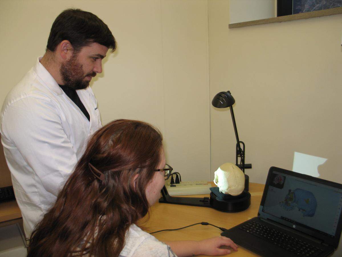 Corey Ragsdale and an SIUE student use a 3D scanner to make a digital representation of a human skull. Ragsdale said "there's a huge amount of information we can get from a human skeleton," including the age of the person within five years.