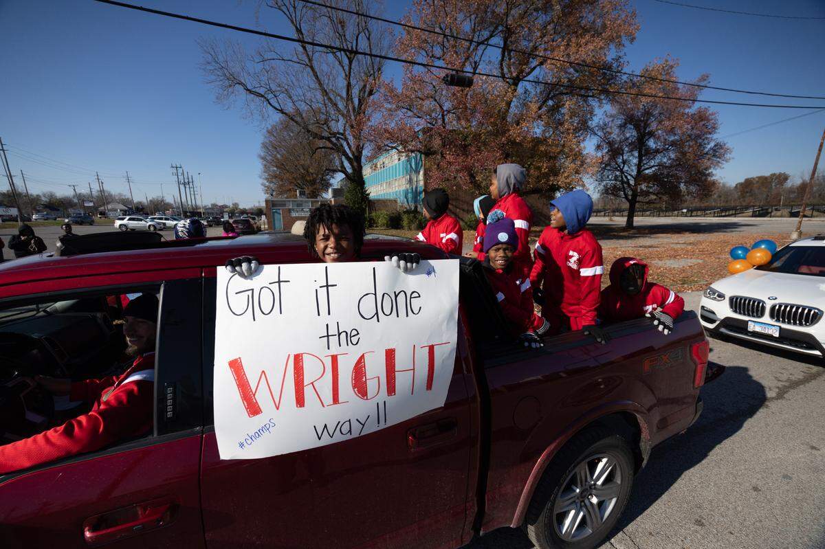 Junior football players, hopeful for a spot on the high school varsity Flyers when the time comes, celebrate during a state victory parade on Dec. 4, 2024.