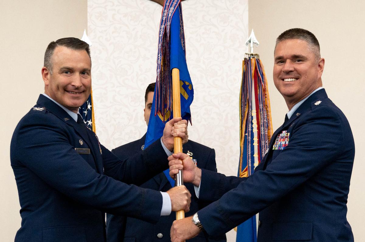U.S. Air Force Lt. Col. Daniel Flanagan, 375th Comptroller Squadron incoming commander, assumes command after receiving guideon from Col. Chris Robinson, 375th Air Mobility Wing commander, during a change of command ceremony on Scott Air Force Base. Flanagan previously served as a budget analyst in the Financial Management Directorate, Headquarters Air Mobility Command, Scott AFB.