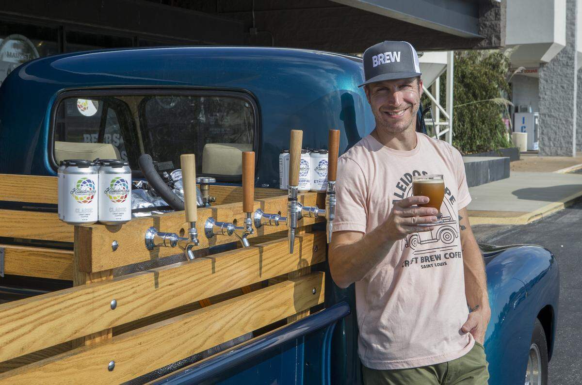 Chris Thele, co-founder of Kaleidoscope Craft Brew Coffee poses by one of his mobile coffee dispensers a 1952 chevy truck.