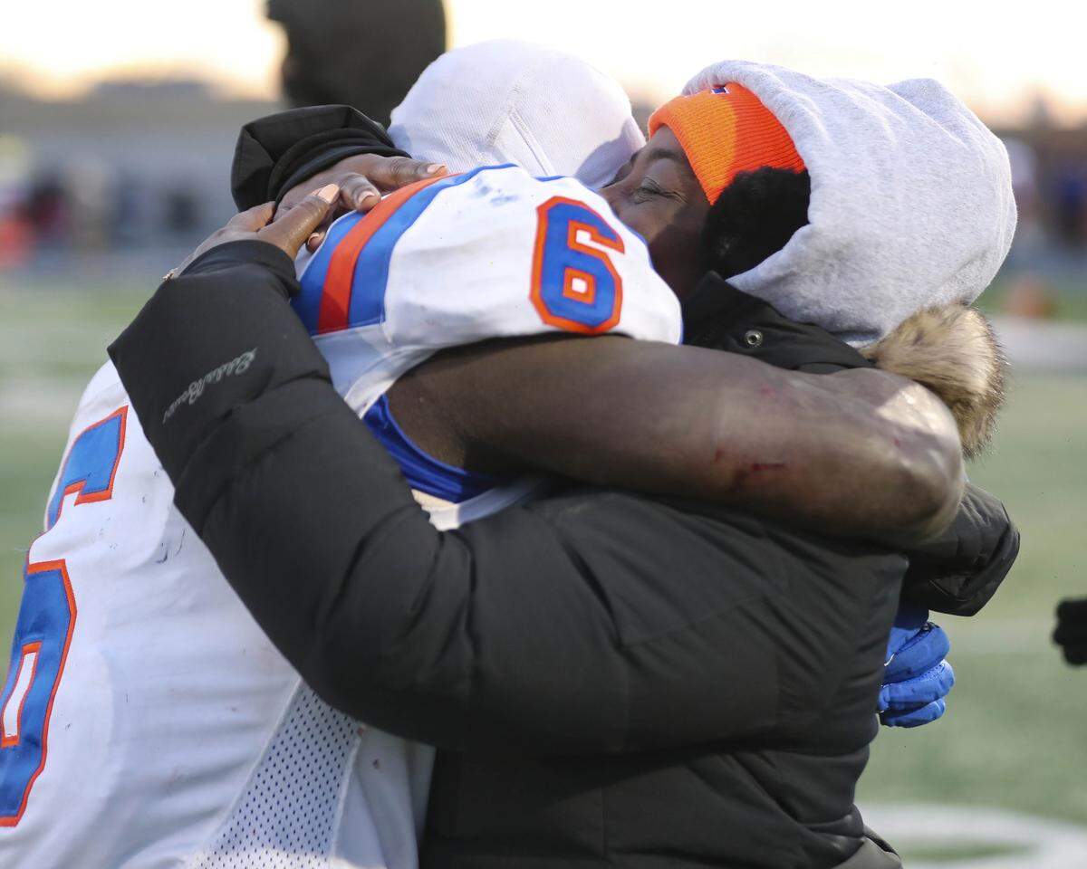 An emotional TaRyan Martin and his mom embrace after the IHSA Class 6A semifinal game against Lemont. Martin’s 349 rushing yards and three touchdowns helped the Flyers defeat Lemont 32-29 and punch their ticket to the state championship game.