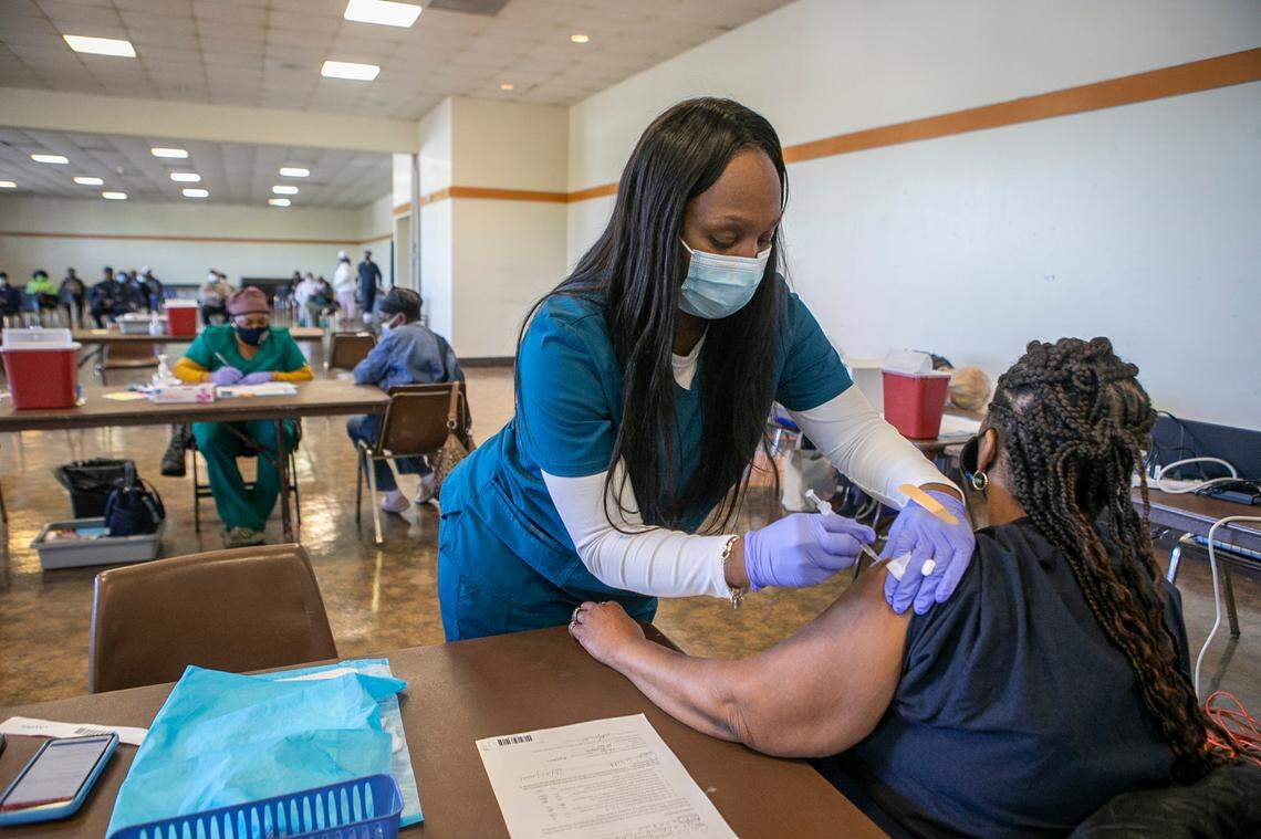 Kanisha Ward, LPN, gives Carlis Weathers, 60, of Belleville her second dose of the COVID-19 vaccine earlier this year. According to data released by the Illinois Department of Public Health on Wednesday, 290,839 metro-east residents have been fully vaccinated out of the estimated 660,225 who live in the region, or approximately 44%.