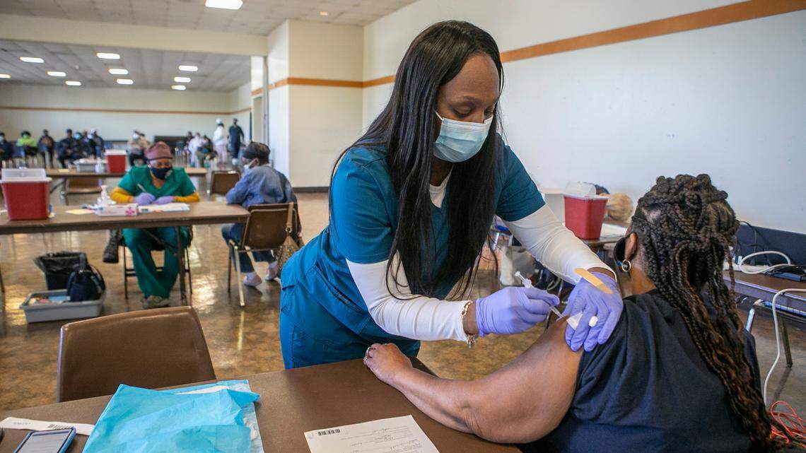 Kanisha Ward, LPN, gives Carlis Weathers, 60, of Belleville her second dose of the COVID-19 vaccine earlier this year. According to data released by the Illinois Department of Public Health on Wednesday, 290,839 metro-east residents have been fully vaccinated out of the estimated 660,225 who live in the region, or approximately 44%.