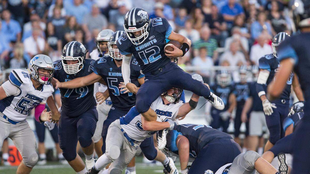 Mater Dei’s Travis Jasper carries the ball during the Freeburg - Mater Dei Varsity football game Friday night in Breese.