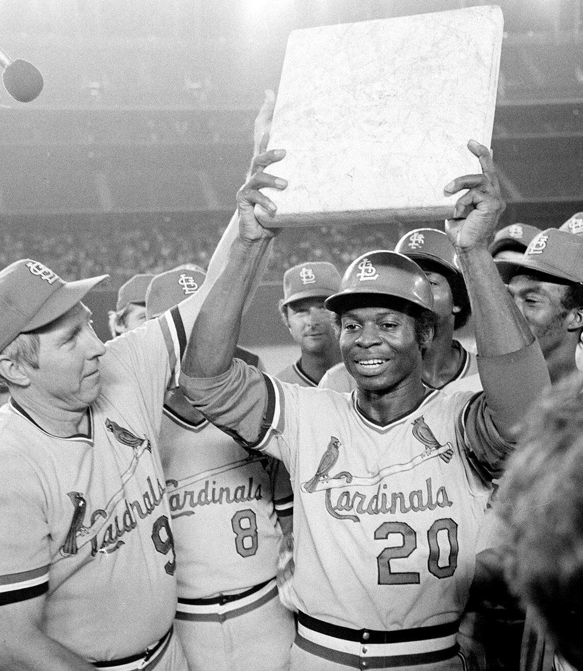 Lou Brock is surrounded by his teammates as he holds second base plate after breaking Ty Cobb’s all-time record of 892 stolen bases in San Diego, August 29, 1977. Brock tied the record in the first inning and broke the record in the seventh by stealing second. At left is team manager Vern Rapp. (AP Photo)
