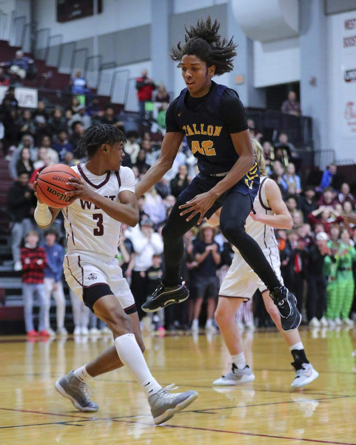 O’Fallon’s Rini Harris plays tight defense against Belleville West’s Quincy Cotton late in the game during Friday’s Southwestern Conference showdown. Both teams were back in action Saturday.