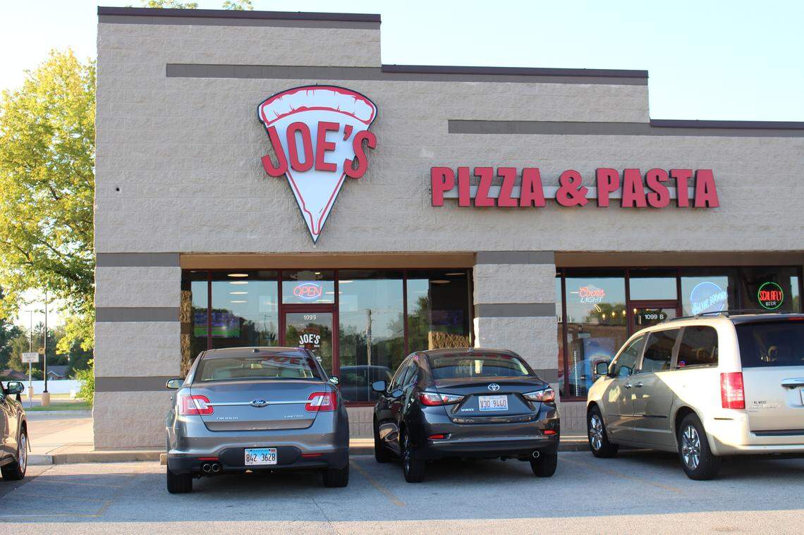 Cars parked outside restaurants, such as these in front of Joe’s Pizza & Pasta in Collinsville last August, don’t mean businesses are violating the stay-at-home order. They can offer carryout, curbside pickup and delivery services.