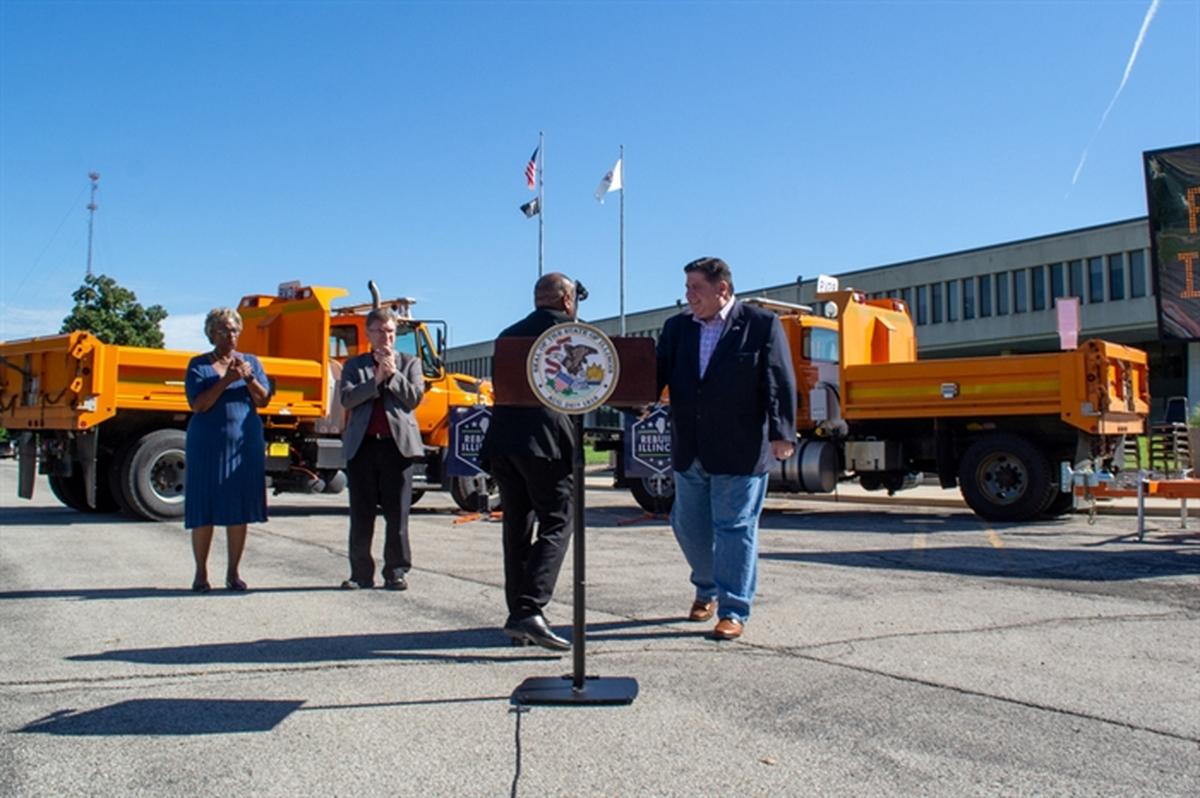 Gov. J.B. Pritzker shakes the hand of Illinois Department of Transportation Secretary Omer Osman outside the IDOT building in Springfield on Friday. The pair and other local officials outlined the state’s six-year infrastructure spending plan.