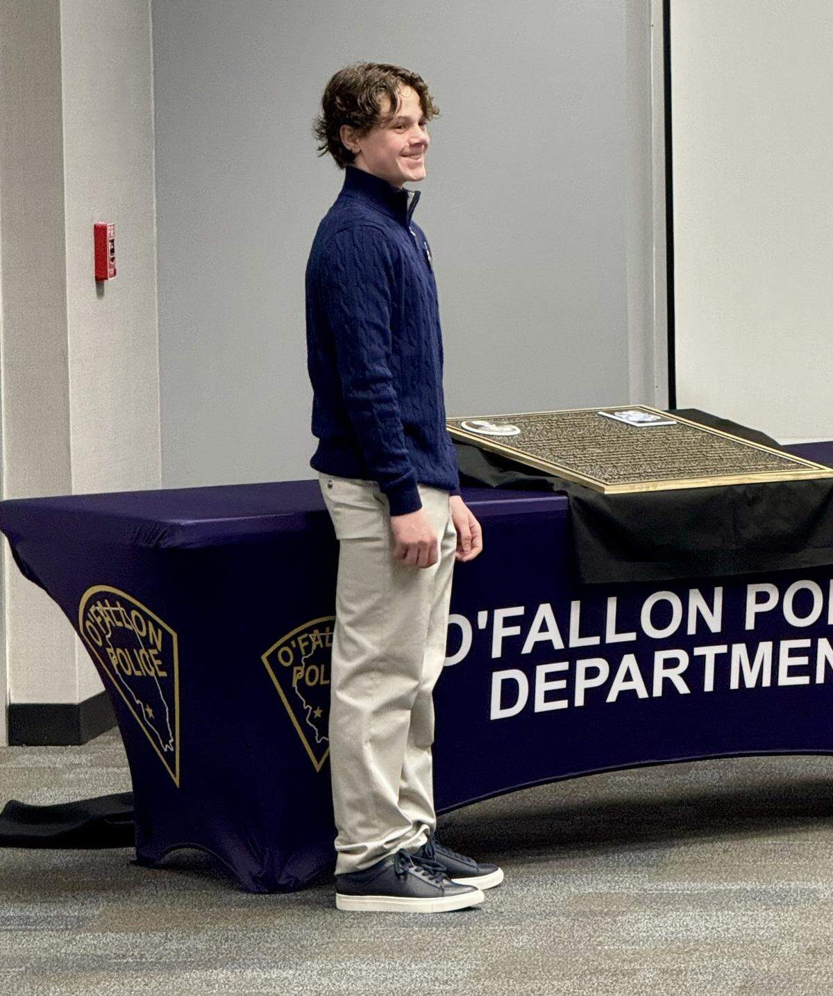 Schmitt’s great-great grandson Hank Schmitt unveiled the plaque. He is wearing his great-great grandfather’s original police badge.