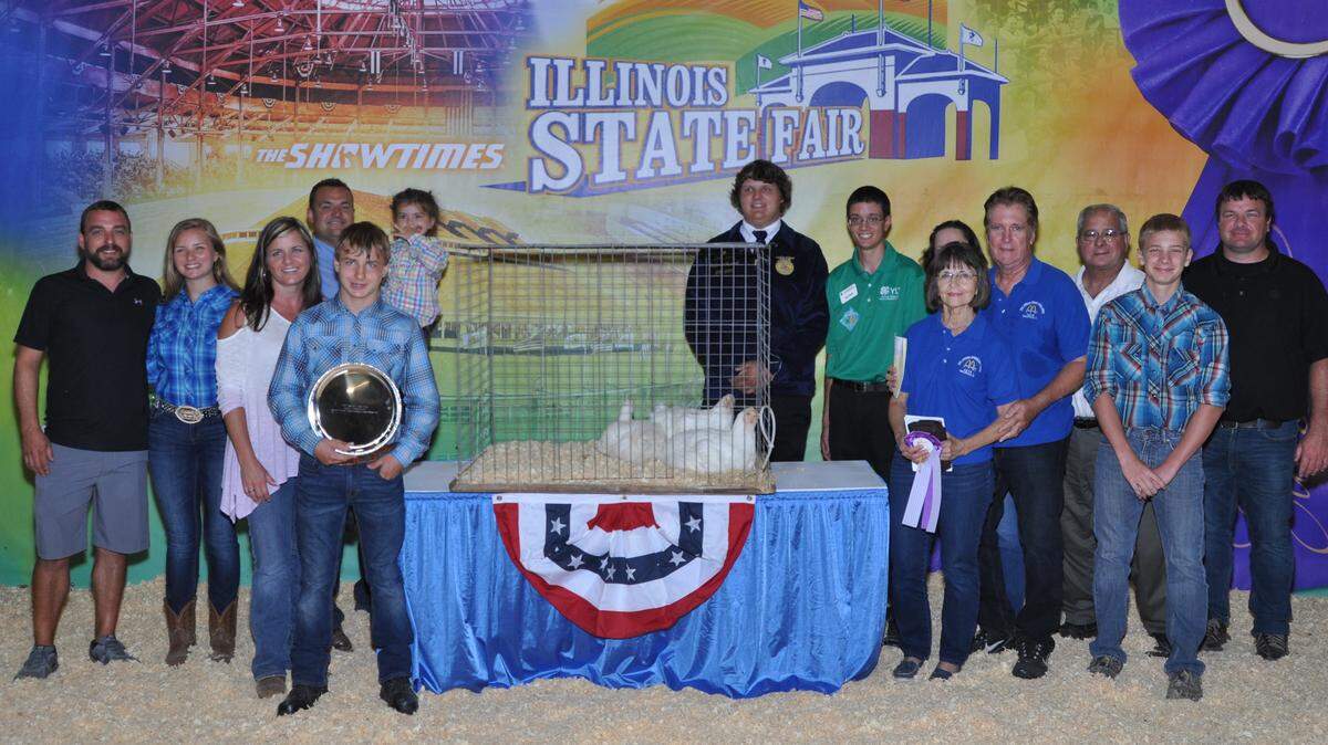 Grant Wilderman holds the silver plate in front of his Grand Champion cornish cross chickens at the Illinois State Fair. At the 2018 Governor’s Sale of Champions, Wilderman’s chickens sold for $4,000.
