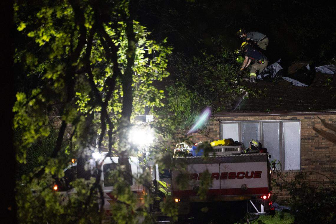 Fire crews check a house along Rt. 160 between Trenton and Lebanon, where a tornado blew through and caused damage to homes and property.